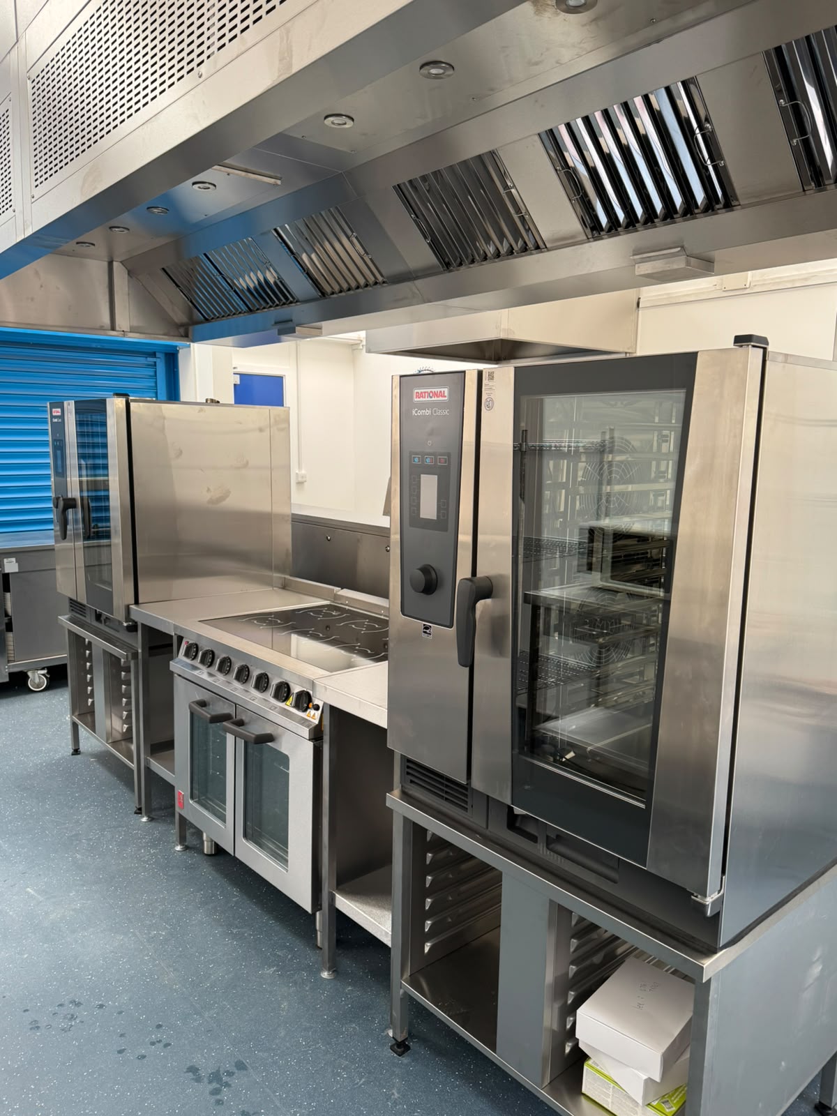 Energy-efficient commercial ovens and cooking equipment in the refurbished school kitchen.