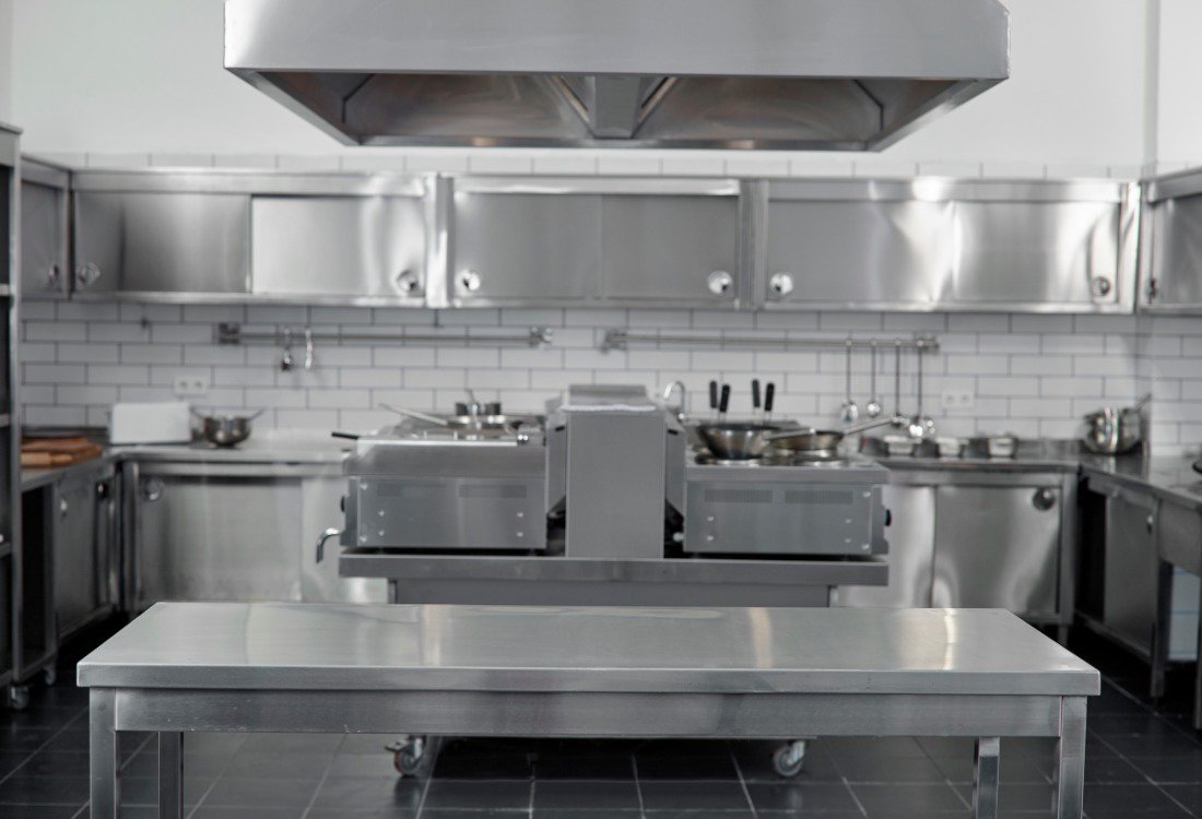 A bespoke stainless steel table was made to perfectly fit this kitchen layout.