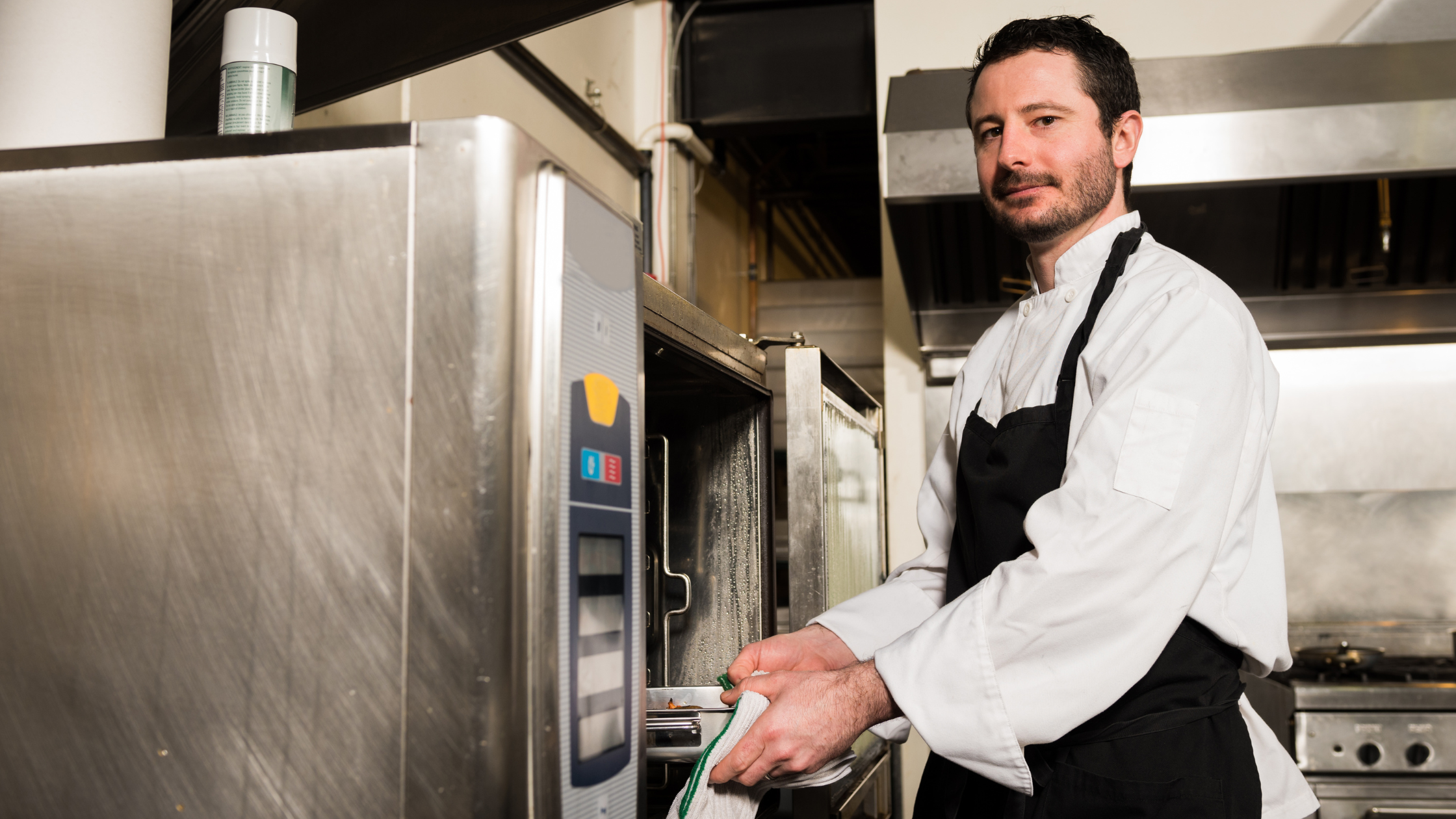 A chef using one of the best commercial combi-oven brands because of it's ease of use and reliability. 
