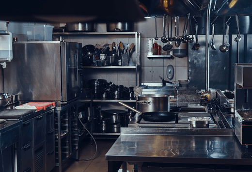 Multiple bespoke stainless steel tables, that were created to work with the layout of the kitchen and facilitate its flow.