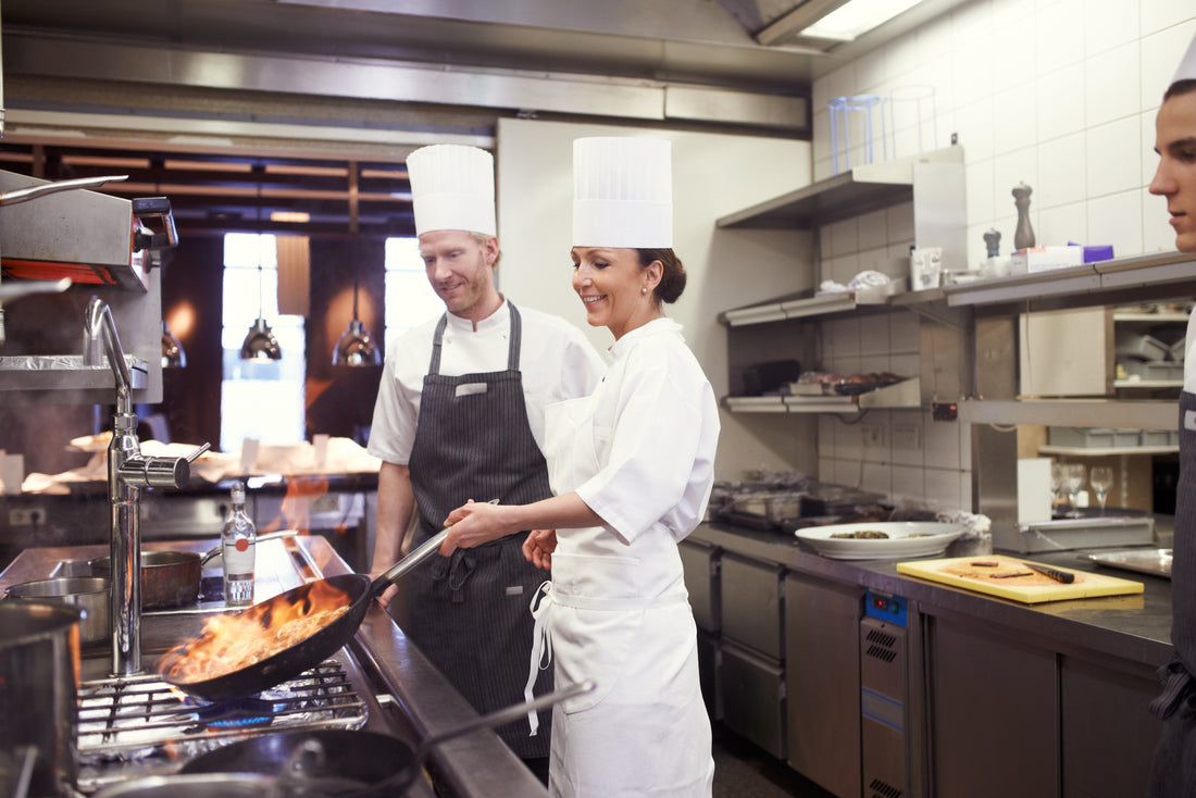 Professional chef using easy-to-use kitchen equipment in a modern kitchen to maintain consistent food service quality.