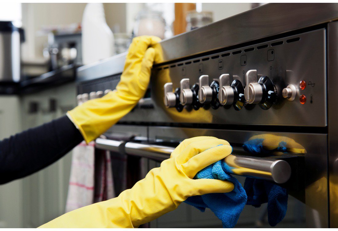 Someone cleaning a commercial high-sped oven.
