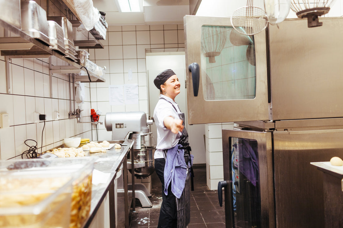 Modern commercial kitchen cooking setup, representing commercial kitchen extraction hood solutions and alternative ventilation systems.