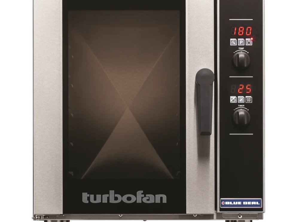 A Blue Seal convection oven is used in a school to cook the food. 