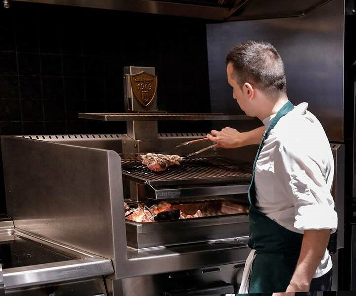 Chef at Josper oven cooking meat